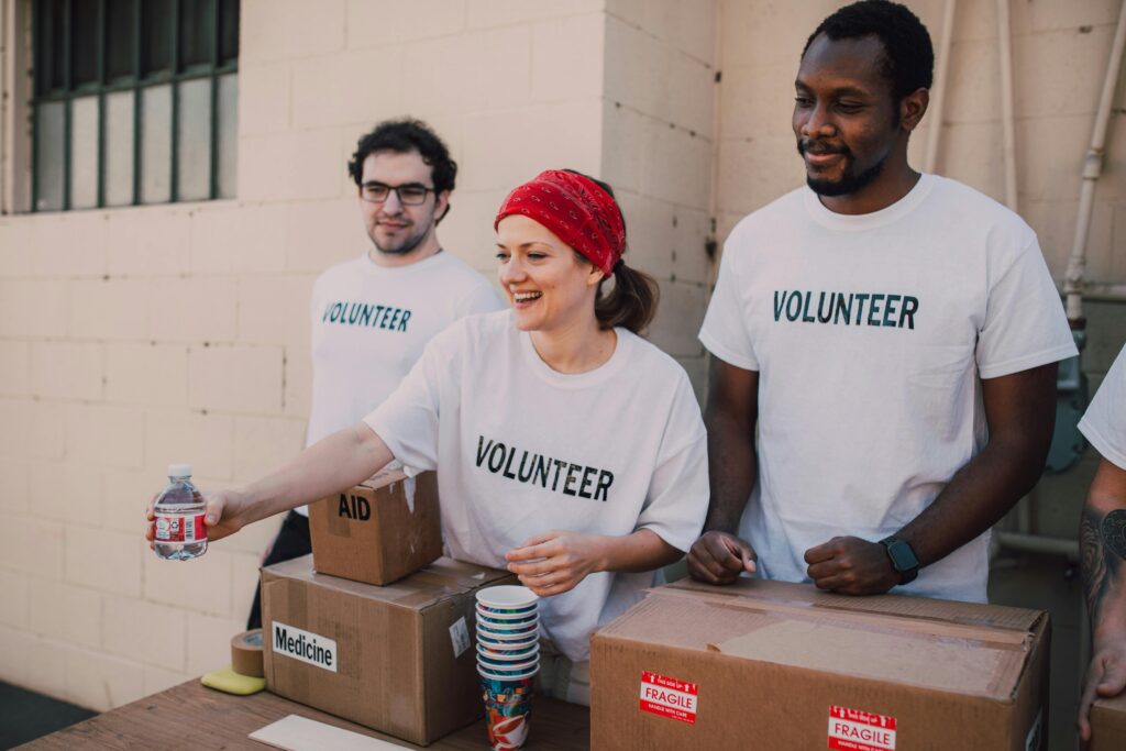 Volunteers distributing aid at an outdoor donation center, promoting social impact and diversity.